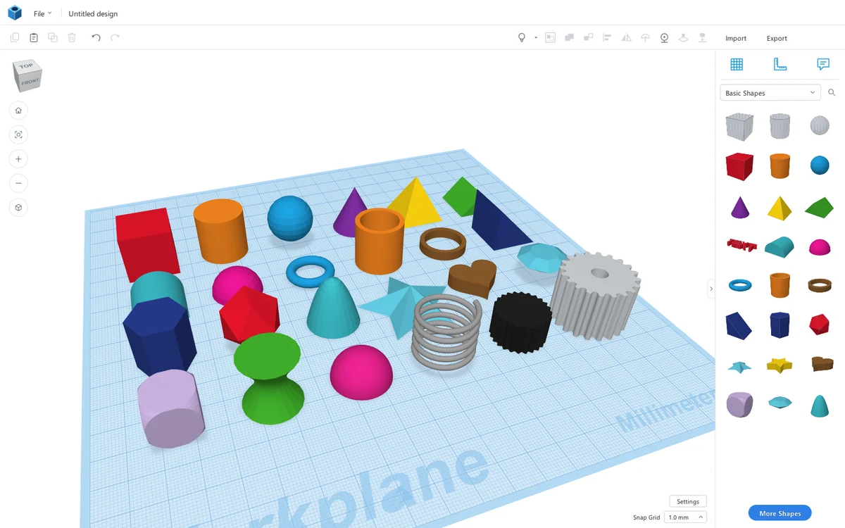 Two dozen colourful shapes arranged on the ScottiCAD workplane: cubes, cylinders, a torus, a spring, a gear, a star and more.