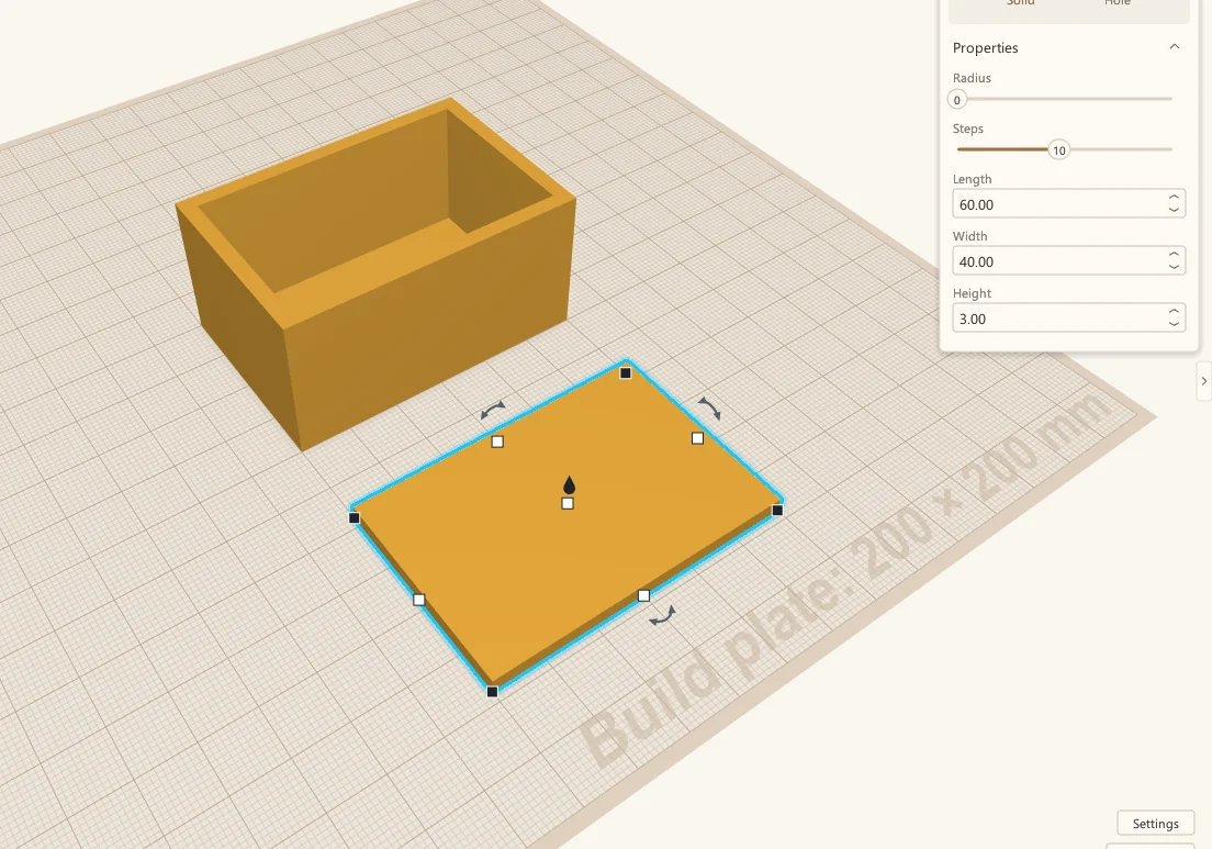The hollowed-out box, and a flat 60 by 40 by 3 mm lid selected beside it.