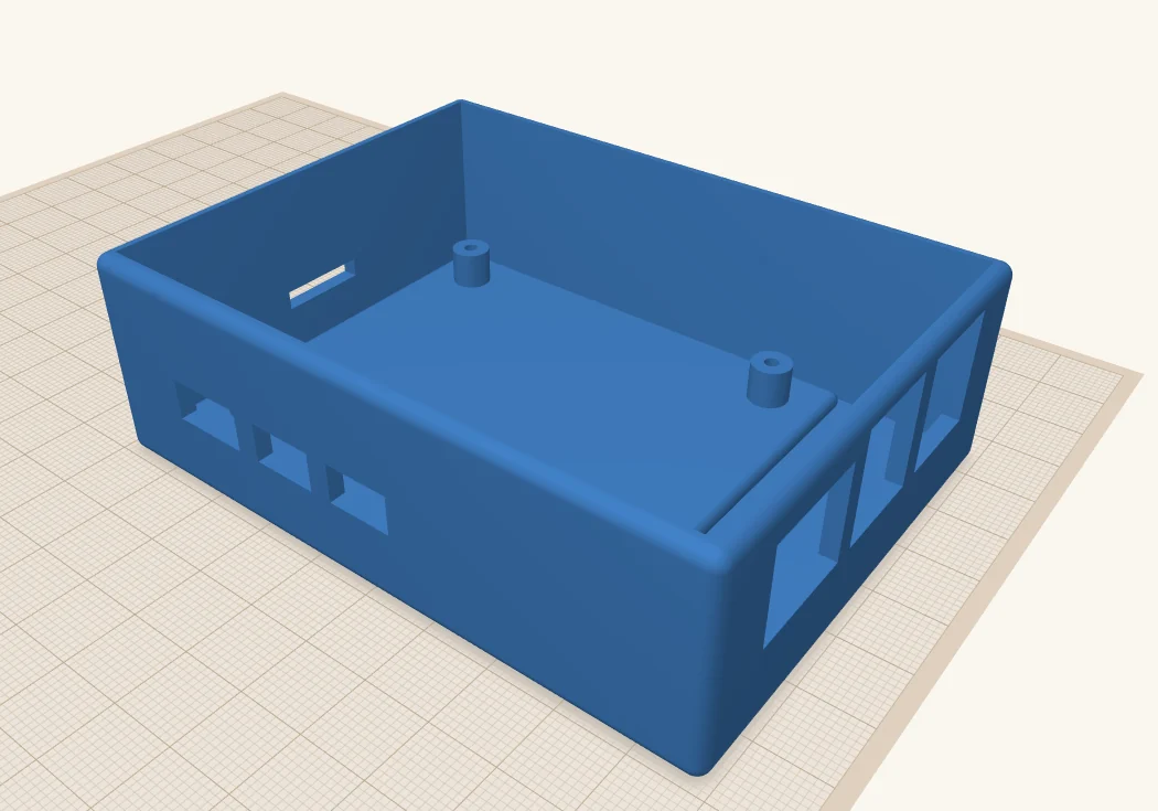 The finished blue case: large openings for the Ethernet and USB ports on the right, smaller ones for USB-C and HDMI on the left, and screw posts inside.