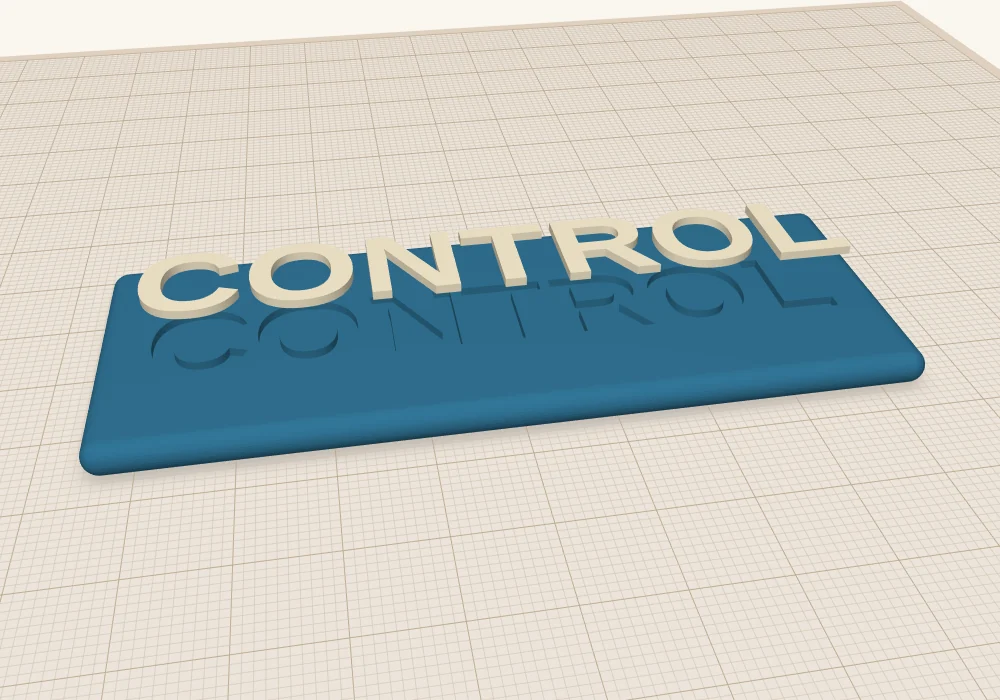 The cream letters lifted above the blue plate, showing the word-shaped hole cut into the plate underneath.