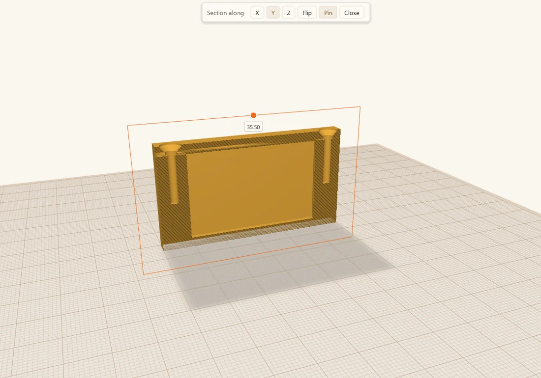 The box cut along Y, showing two posts with their pilot holes and the countersinks in the lid above them.