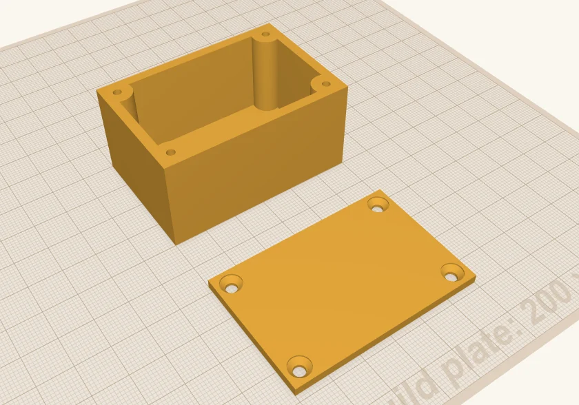 The same box with a screw post in each corner, each with a pilot hole, and a flat lid beside it with four countersunk holes.