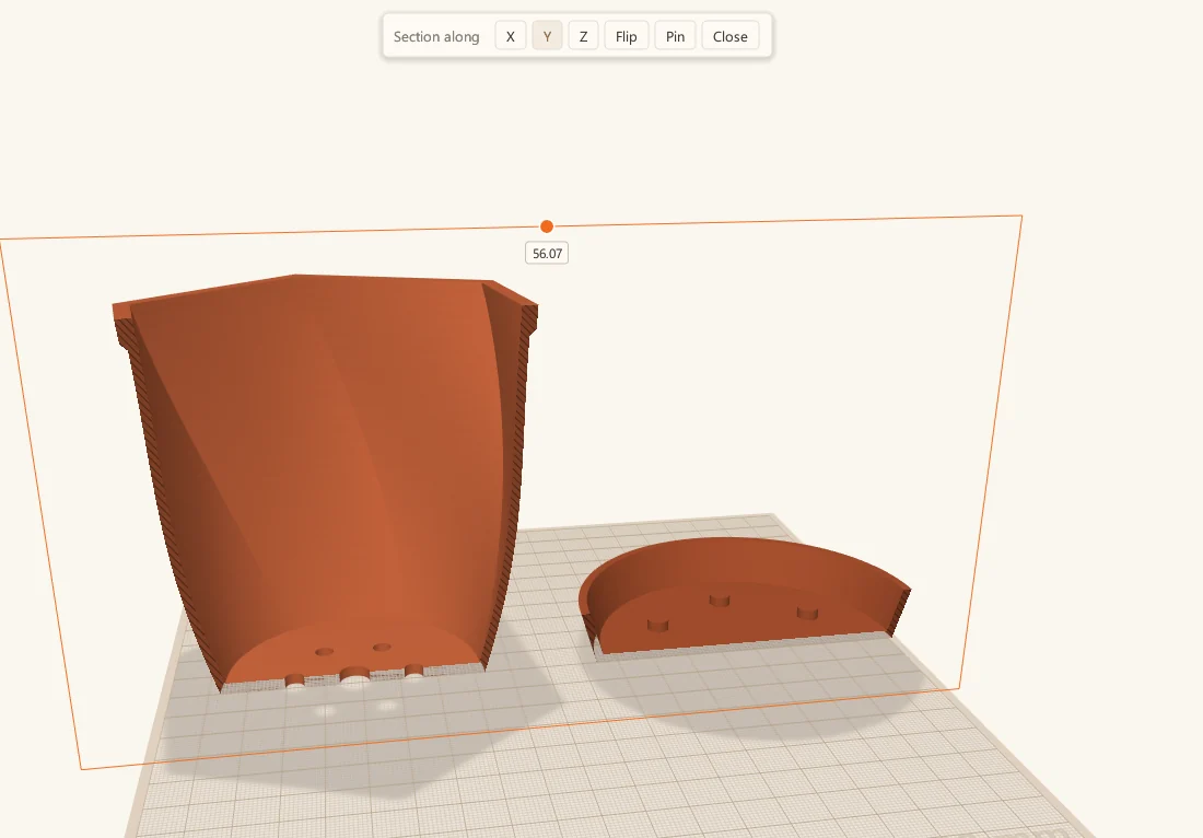 Section view in ScottiCAD cutting through a twisted plant pot and its saucer, showing the wall thickness and drainage holes.